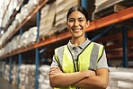 Happy woman, portrait and logistics with confidence in warehouse for supply chain or storage management. Young female person or employee with smile and arms crossed in shipping industry at depot