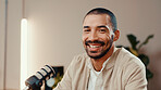 Microphone, podcast and portrait of man in studio for broadcast, interview or live streaming. Radio, smile and talk show with host or presenter in production office for subscription entertainment