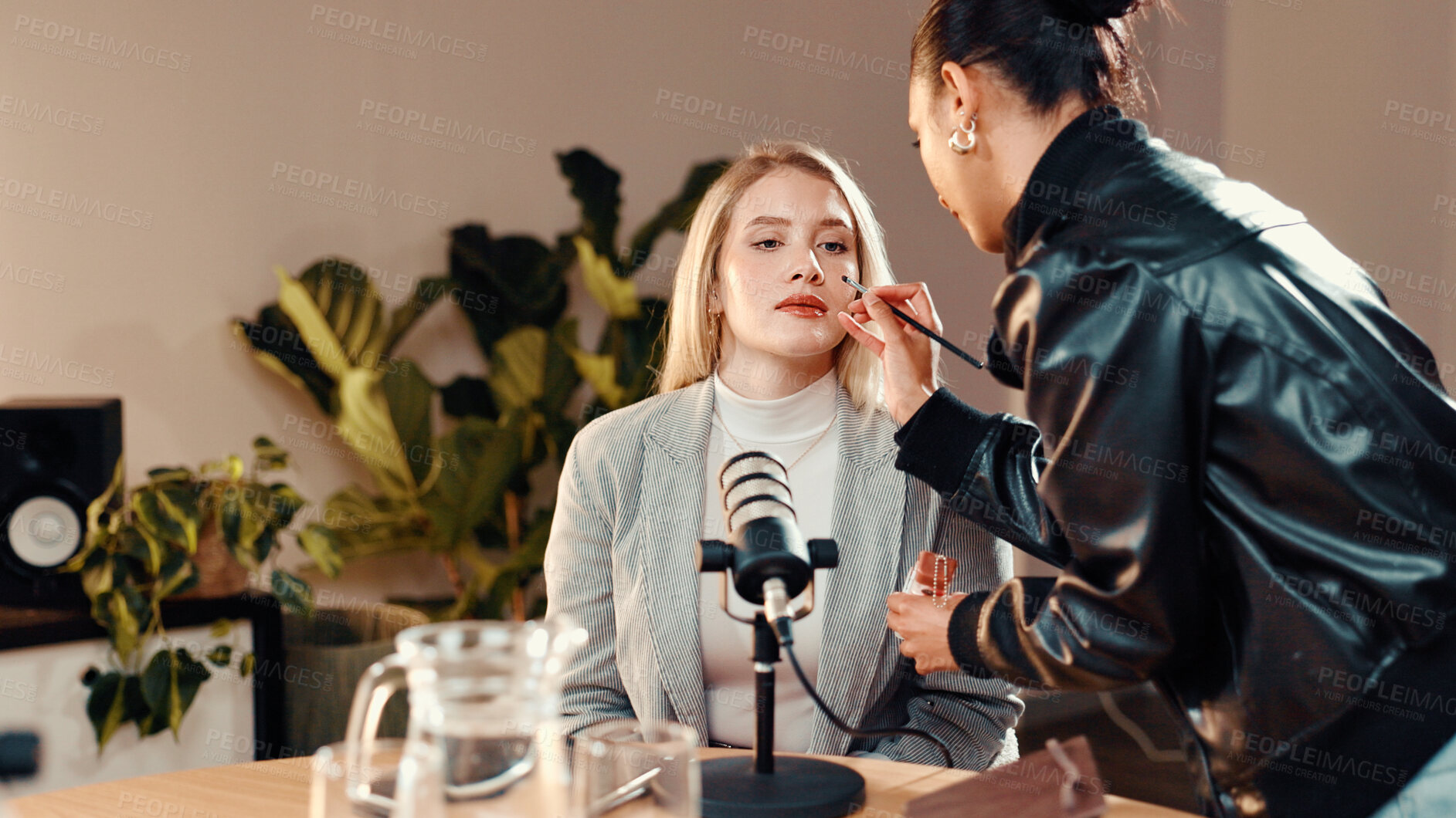 Buy stock photo Makeup brush, beautician and presenter in recording studio for podcast, getting ready or online show. Live stream, radio broadcasting or woman with cosmetics for host, content creation and microphone