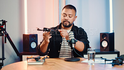 Buy stock photo Influencer, live streaming and man with drone for review, feedback and advice with tech in studio. Content creator, speaker and person with equipment for product test, tutorial or talking to audience