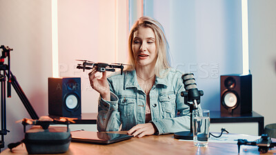 Buy stock photo Influencer, talking and woman with drone for review, feedback and live stream with tech in studio. Content creator, speaker and person with equipment for product test, tutorial or advice for audience