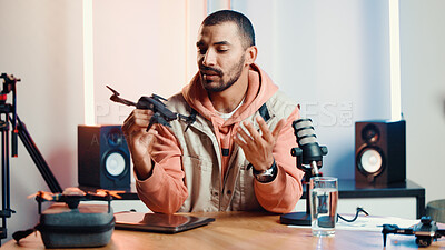 Buy stock photo Content creator, live streaming and man with drone for review, feedback and advice with tech in studio. Influencer, speaker and person with equipment for product test, tutorial or talking to audience