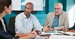 Colleagues, group and discussion with paperwork in boardroom, meeting and data analysis for company. Office, business analyst and people with report for performance, conversation and collaboration