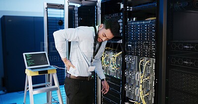 Buy stock photo Programmer, back pain and man in server room, joint injury and laptop with inflammation. Employee, technology or person with database, fatigue or burnout with muscle tension, exhausted or maintenance