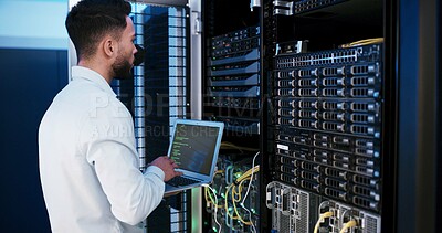 Buy stock photo Man, laptop and typing for programming in server room, hardware and inspection for IT solution at company. Person, cybersecurity and assessment with computer, coding and update software for system