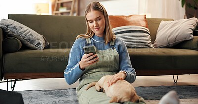 Buy stock photo Cuddle, phone or relax with puppy and woman on floor in living room of home together for break. App, communication or rest with owner and pet Labrador in apartment for bonding or social media
