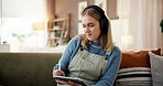 Tablet, headphones and woman with stylus on sofa in home with art, creativity or project for university. Pen, technology and female student with graphic design assignment for college in living room.