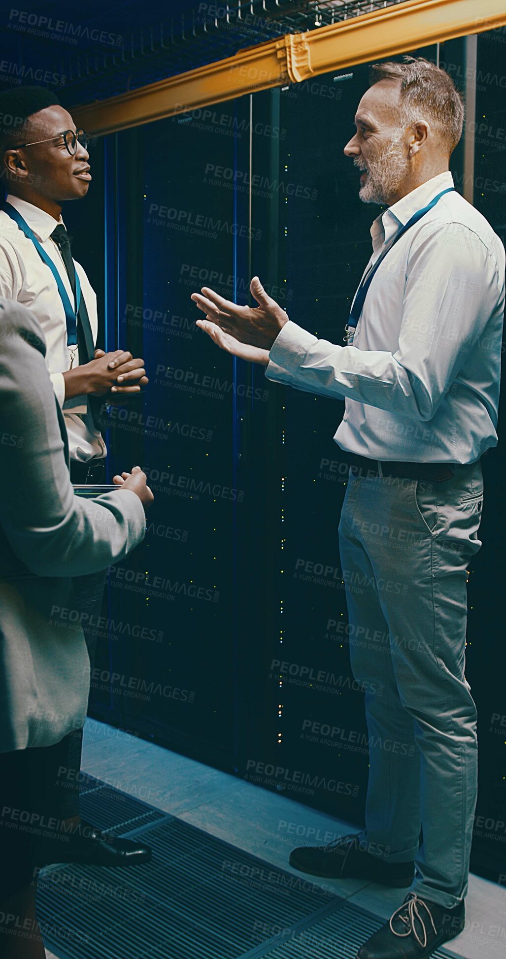 Buy stock photo Collaboration, conversation and mainframe with people in server room for network administration. Cybersecurity, explain and tech support with team in data center for communication or maintenance
