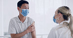 Man, doctor and talk for flu vaccine at clinic, explain or immune system booster with face mask. Woman, medical professional and patient with ppe, pharmaceutical shot and virus prevention at hospital