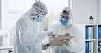Scientist, team and clipboard with PPE, discussion and document for medical research or study. People, teamwork and data analysis with test results, biotechnology and hazmat suit for healthcare
