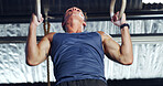 Athlete, man and exercise with gymnastics rings for fitness, pull up and training for body strength. Male person, equipment and intense workout for weightlifting, muscle endurance and power challenge