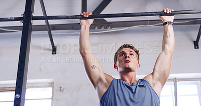 Buy stock photo Workout, pull up bar and fitness with man in gym for arm exercise, health and challenge. Strength training, bodybuilder and low angle with person in sports club and equipment for athlete and strong