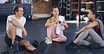 Smile, athlete and people relax at gym for fitness, training discussion and break from recovery. Happy, group and women resting with personal trainer, sports workout and membership for wellness goals