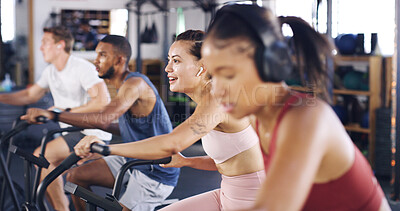 Buy stock photo Spin class, fitness and earphones with woman in gym for intense workout, music and cycling challenge. Cardio, streaming and stationary bike machine with people in sports club for health and energy
