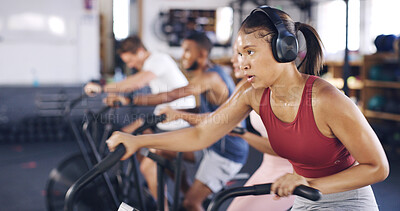 Buy stock photo Spin class, cardio and headphones with woman in gym for intense workout, music and cycling challenge. Fitness, streaming and stationary bike machine with people in sports club for health and energy