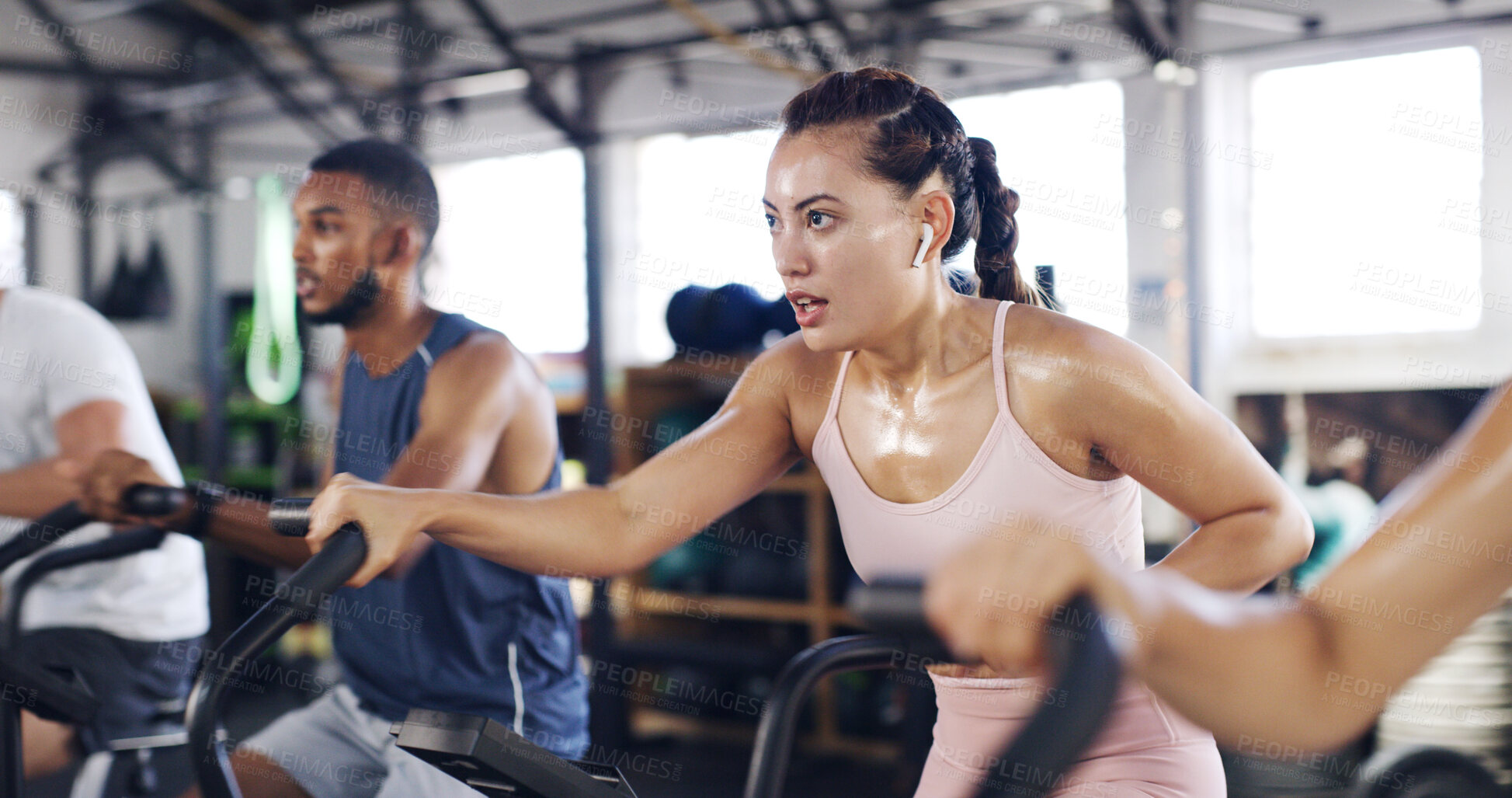 Buy stock photo Spin class, exercise and earphones with woman in gym for intense workout, music and cycling challenge. Fitness, streaming and stationary bike machine with people in sports club with sweat and energy