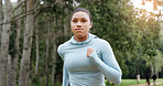 Woman, running and outdoor for fitness in park, training routine and speed for cardio challenge at sunset. Girl, athlete and perspective for workout, exercise or jog in nature for wellness in summer