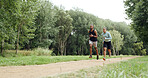 Fitness, couple and running in forest for wellness, health and training for race outdoor. Man, woman and trail runner in woods for cardio workout, endurance exercise and practice on path in nature