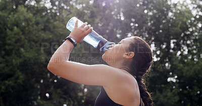 Buy stock photo Woman, drinking water and fitness in park, break and profile with hydration, tired and electrolytes in nature. Girl, bottle and aqua for detox, thirst or fatigue with training routine in Colombia