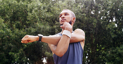 Buy stock photo Man, warm up and stretching arms in nature for fitness, preparation and thinking for wellness. Outdoor, park and training for exercise with runner, getting ready and flexibility with low angle