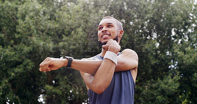 Buy stock photo Fitness, stretching and man thinking outdoor in nature for exercise, training and smile. Male athlete, start arm muscle warm up and happy at park for workout, wellness and low angle of health