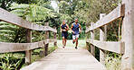 Athlete, couple and running on bridge for fitness, team exercise and cardio training. People, runner and sports workout with endurance challenge, marathon practice and wellness competition in nature