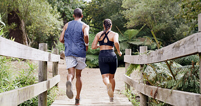 Buy stock photo Back, running and athlete couple on bridge for fitness, team exercise and cardio training. People, runner and sports workout with endurance challenge, marathon practice and wellness hobby in nature
