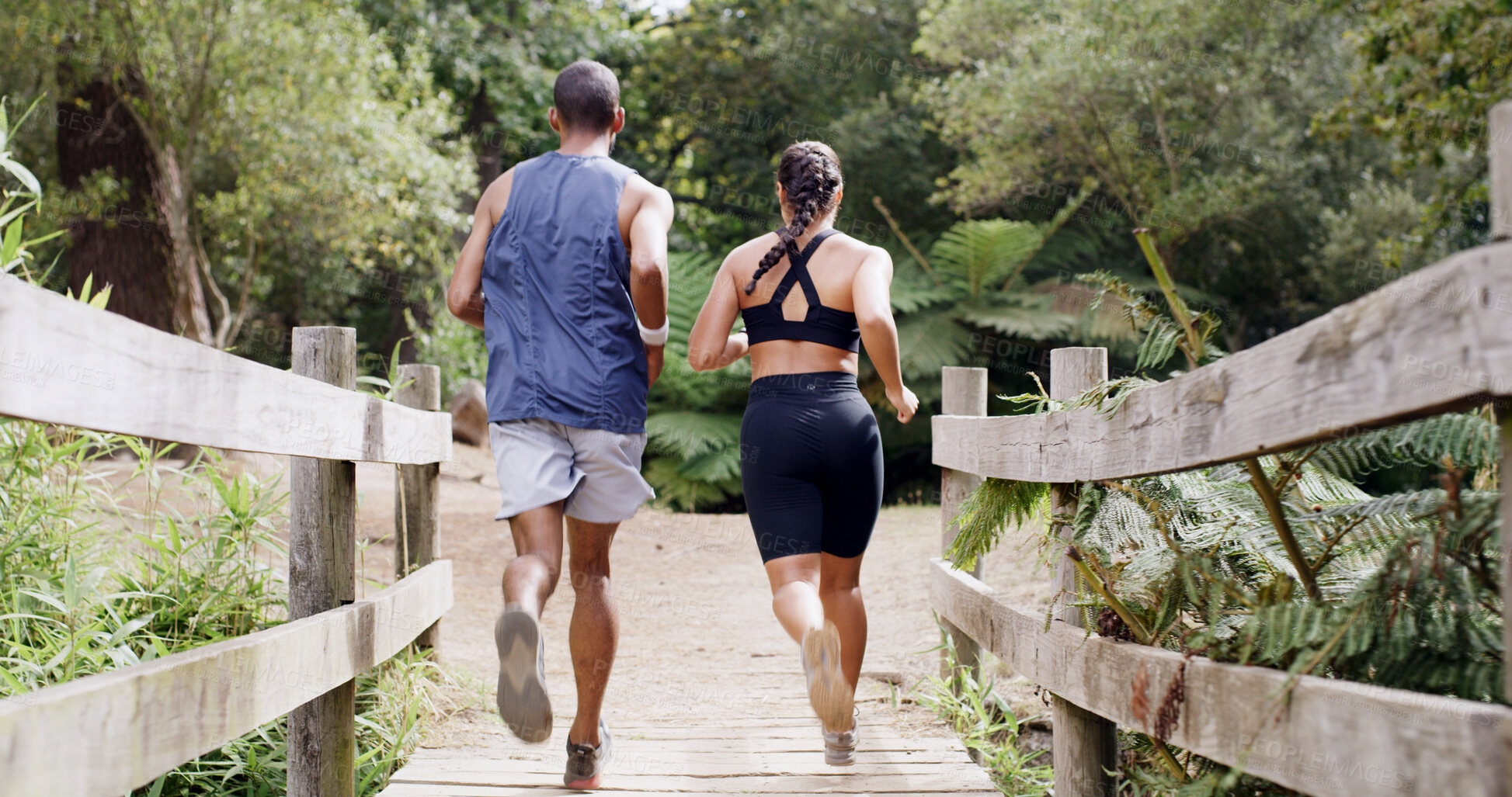 Buy stock photo Back, running and athlete couple on bridge for fitness, team exercise and cardio training. People, runner and sports workout with endurance challenge, marathon practice and wellness hobby in nature