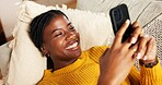 Black woman, mobile and relax on couch with social media, text message and reading online blog. Person, phone and smile in home living room for funny email, meme website and chill with chat platform