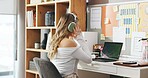 Woman, headphones and creative freelancer with laptop in home for online business or innovation. Female person, remote work or listening with technology, audio or computer for digital news in house