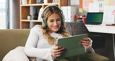 Buy stock photo Remote work from home, tablet and woman on sofa, headphones and creativity with content creation. Person, apartment or freelancer on couch, tech and smile with subscription, app or online streaming