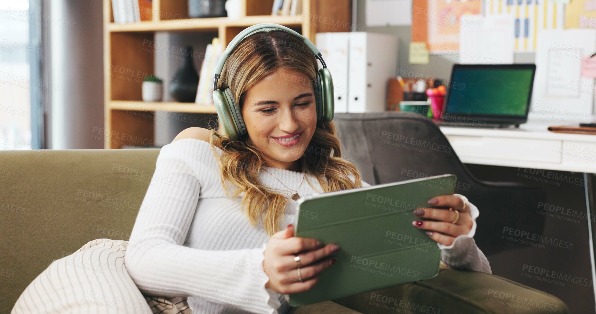 Buy stock photo Remote work from home, tablet and woman on sofa, headphones and creativity with content creation. Person, apartment or freelancer on couch, tech and smile with subscription, app or online streaming