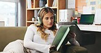 Woman, headphones and reading with tablet in home for remote work, journalism or audio book. Female person, journalist or freelancer with technology on sofa for online story or research in house