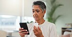 Phone, senior woman and search pills in home for medication benefits, ingredients or side effects. Old person, mobile app or reading tablet label in house for dosage instruction or pharmaceutical FAQ