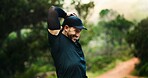 Happy, stretching and man in nature with fitness, training goals and exercise target for wellness. Smile, athlete or person outdoor in forest with space, trail run preparation and warm up for workout