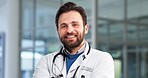 Portrait, man and doctor with smile in hospital for career pride, about us and healthcare services. Happy, male person and ambition for medical support, cardiology surgeon and confidence of wellness
