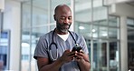 Smartphone, surgeon and black man in hospital, healthcare and digital app for social media. African person, medical service and professional in clinic, cellphone and internet with online chatting