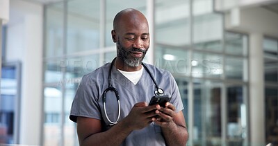 Buy stock photo Smartphone, surgeon and black man in hospital, healthcare and digital app for social media. African person, medical service and professional in clinic, cellphone and internet with online chatting