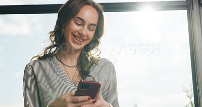 Buy stock photo Phone, happy and businesswoman in office with networking, communication or contact on mobile app. Flare, window and female corporate employee with chatting online with cellphone in workplace.