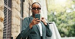 Shopping bags, cellphone and black woman in city, sunglasses and mobile app with commute. Outdoor, shades and African person with smartphone, retail and fashion with discount deal, travel or internet
