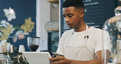 Buy stock photo Man, barista and tablet at coffee shop, scroll and phone for checklist, stock or inventory management. African person, waiter and tech with app, smartphone or click for menu, sales or review at cafe