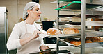 Restaurant, pastry chef and woman in commercial kitchen with paperwork, checklist and quality control. Baker, clipboard and stock for catering, bakery industry and production for breakfast or snack
