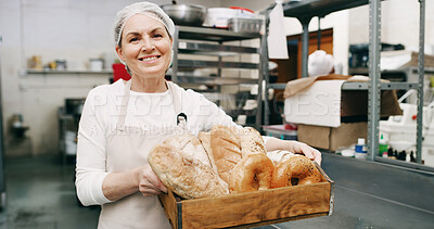Buy stock photo Woman, bakery and bread basket in portrait with smile, pride and entrepreneur with product at store. Mature person,  happy and small business owner in kitchen for pastry, buns and bagels in Germany