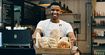 Black man, portrait and small business with bread in bakery for food, breakfast or wheat. Male person, pastry chef or baker with smile or basket of loafs or rolls in cafe for hospitality service