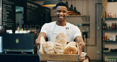 Buy stock photo Black man, portrait and small business with bread in bakery for food, breakfast or wheat. Male person, pastry chef or baker with smile or basket of loafs or rolls in cafe for hospitality service