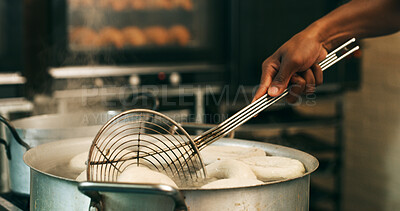 Buy stock photo Hands, baker or tool for frying donuts in kitchen for breakfast order, baking process or gastronomy. Catering, person or strainer in bakery for small business, snack production or dessert preparation