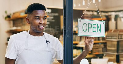 Buy stock photo Black man, cafe or welcome with open sign on door for small business or ready for service. Male person, waiter or entrepreneur with label or entrance for trade hour, coffee shop startup or restaurant
