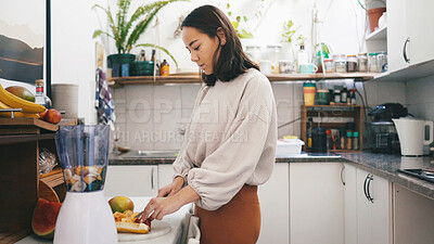 Buy stock photo Cutting, fruit and woman with blender, kitchen and preparing smoothie with ingredients for wellness. Beverage, nutrition and person with equipment for protein shake, gut health and detox in home
