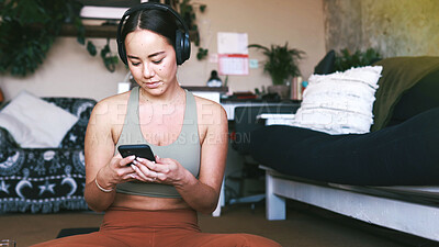 Buy stock photo Fitness, headphones and phone with woman in house for guided meditation, streaming and wellness podcast. Connection, zen and calm sound with person in home for yoga, radio subscription and music