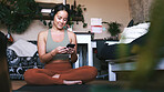 Yoga, headphones and phone with woman in house for guided meditation, streaming and wellness podcast. Connection, zen and calm sound with person in home for fitness, radio subscription and music